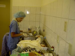 Phyl cleaning linen and instruments at the one and only sink for this