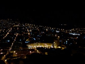 pdr_0095 Looking another direction there is a large building as well as a bull fighting arena in the foreground and more city lights extending into the darkness.