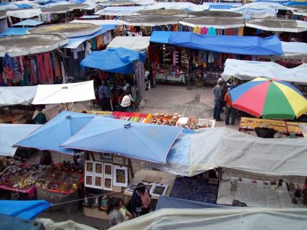 Looking at a small portion of the market place from a second story balcony